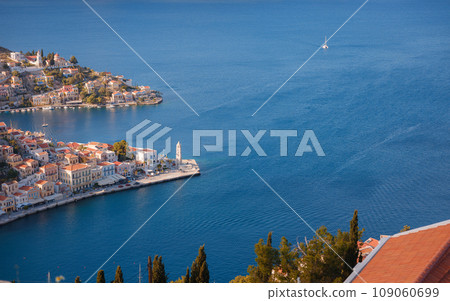 Symi Island, Greece. Greece islands holidays from Rhodos in Aegean Sea. Colorful neoclassical houses in bay of Symi. view of main bay of island, where tourist ferries and yachts moor 109060699