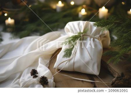 Christmas gift. Packaging in eco-friendly materials, furoshiki fabric. Bokeh, selective focus Christmas gift. Packaging in eco-friendly materials, furoshiki fabric. Bokeh, selective focus 109061091