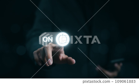 A businessman is shown in the act of touching a virtual toggle switch button, which is used to turn a device on or off. Slider button hologram, Startup business, 109061883
