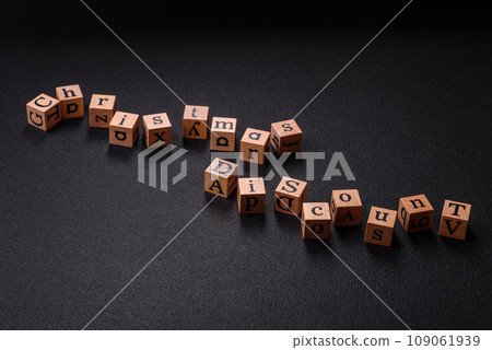 Beautiful Christmas composition with copy space with an inscription in wooden cubes Beautiful Christmas composition with copy space with an inscription in wooden cubes 109061939