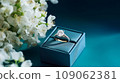 wedding ring in beautiful packaging with white flowers on turquoise background, marriage proposal 109062381