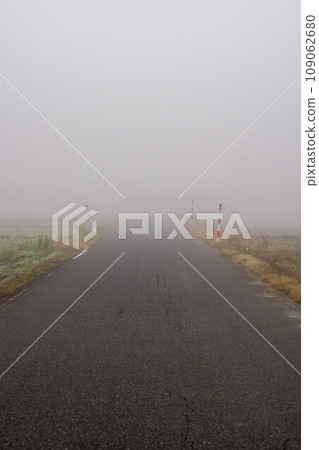 road covered in fog 109062680