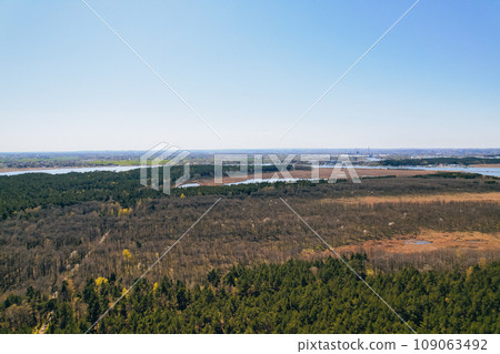 Aerial view drone of river goes into the sea. Delta of Vistula river goes in Baltic Sea in Sobieszewo Gdansk Poland. Forest and small village around Aerial view drone of river goes into the sea. Delta of Vistula river goes in Baltic Sea in Sobieszewo Gdansk Poland. Forest and small village around 109063492
