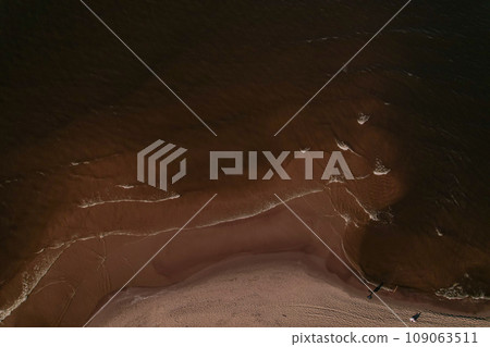 Drone aerial view of waves sea ocean coast. Beach and dunes dark calm sea waves nature landscape captured with drone. Tourism Drone aerial view of waves sea ocean coast. Beach and dunes dark calm sea waves nature landscape captured with drone. Tourism 109063511