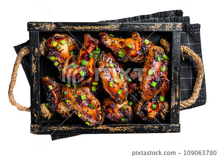 BBQ Chicken wings in Teriyaki sauce with black sesame in a tray. Isolated, white background. BBQ Chicken wings in Teriyaki sauce with black sesame in a tray. Isolated, white background. 109063780