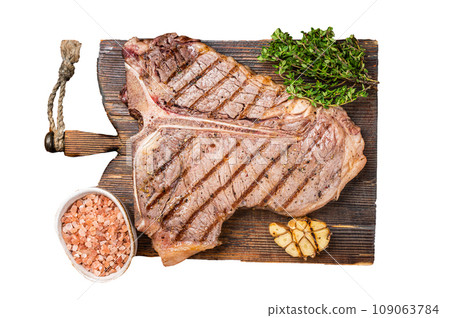 BBQ Roast T bone or Porterhouse beef meat Steak on a wooden board with spices. Isolated, white background. BBQ Roast T bone or Porterhouse beef meat Steak on a wooden board with spices. Isolated, white background. 109063784
