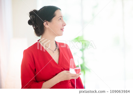 Asian woman at a party. Lady in elegant dress. Asian woman at a party. Lady in elegant dress. 109063984