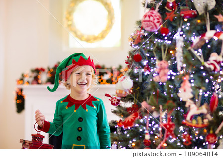 Child decorating Christmas tree. Kid on Xmas eve. Child decorating Christmas tree. Kid on Xmas eve. 109064014