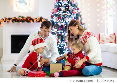 Family at Christmas tree. Parents and kids on Xmas Family at Christmas tree. Parents and kids on Xmas 109064065