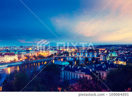 Vintage retro hipster style travel image of travel Prague concept background - elevated view of bridges over Vltava river from Letna Park. Prague, Czech Republic in twilight 109064891