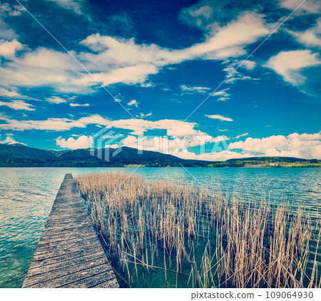 Vintage retro effect filtered hipster style travel image of pier in the lake in countryside, Bavaria, Germany Vintage retro effect filtered hipster style travel image of pier in the lake in countryside, Bavaria, Germany 109064930