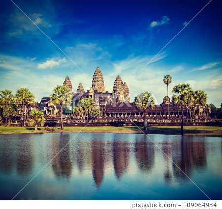Vintage retro effect filtered hipster style travel image of Cambodia landmark Angkor Wat with reflection in water 109064934