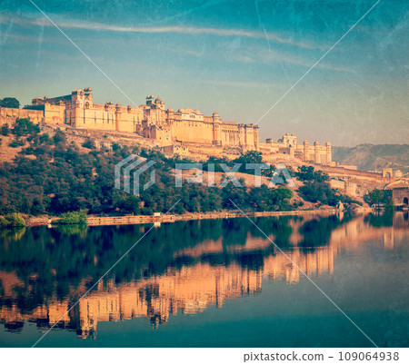 Vintage retro hipster style travel image of Famous Rajasthan landmark - Amer (Amber) fort, Rajasthan, India with grunge texture overlaid Vintage retro hipster style travel image of Famous Rajasthan landmark - Amer (Amber) fort, Rajasthan, India with grunge texture overlaid 109064938
