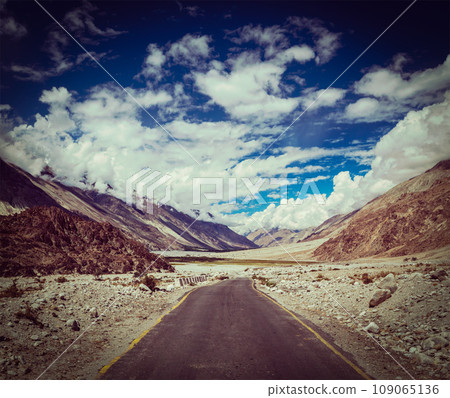 Vintage retro effect filtered hipster style travel image of Road in Himalayan landscape in Nubra valley in Himalayas. Ladakh, India Vintage retro effect filtered hipster style travel image of Road in Himalayan landscape in Nubra valley in Himalayas. Ladakh, India 109065136