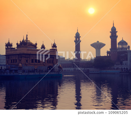 Vintage retro hipster style travel image of Sikh gurdwara Golden Temple (Harmandir Sahib) on sunrise. Amritsar, Punjab, India Vintage retro hipster style travel image of Sikh gurdwara Golden Temple (Harmandir Sahib) on sunrise. Amritsar, Punjab, India 109065205
