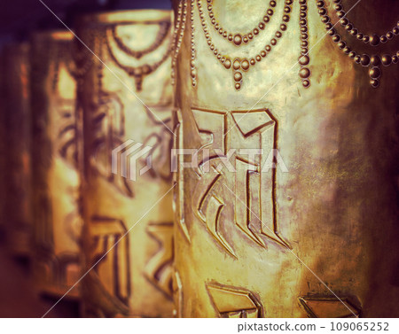 Vintage retro hipster style travel image of Tibetan Buddhist prayer wheels in Buddhism temple. Shallow depth of field. McLeod Ganj, HImachal Pradesh, India 109065252