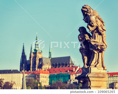 Vintage retro hipster style travel image of statue on Charles Brigde with St. Vitus Cathedral in background in Prague Vintage retro hipster style travel image of statue on Charles Brigde with St. Vitus Cathedral in background in Prague 109065265