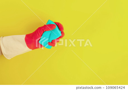 Hand in a rubber glove holds a sponge Hand in a rubber glove holds a sponge 109065424
