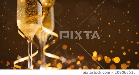 Two New Year's glasses of champagne with highlights on a colored background Two New Year's glasses of champagne with highlights on a colored background 109065533