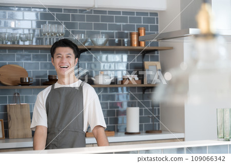 Image of a man standing in the kitchen with a smile on his face, increasing store sales, etc. Image of a man standing in the kitchen with a smile on his face, increasing store sales, etc. 109066342