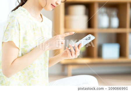 A woman checking her smartphone. (parts) 109066991