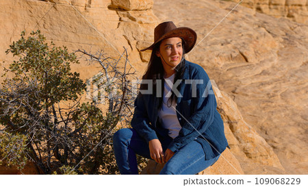 Young woman in western outfit enjoying the tranquility in a canyon of the Nevada desert 109068229