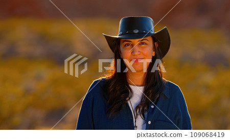 Portrait shot of a cowgirl in the desert at sunset 109068419