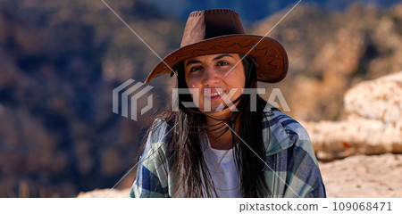 Young woman in a western style outfit exploring the amazing Red Rock Canyon in Nevada Young woman in a western style outfit exploring the amazing Red Rock Canyon in Nevada 109068471