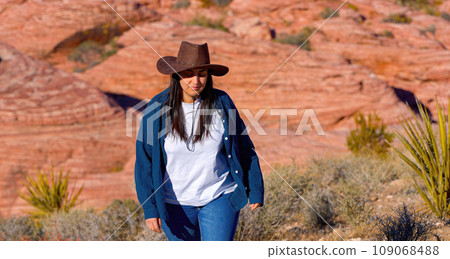 Young cowgirl walking alone through the desert of Nevada Young cowgirl walking alone through the desert of Nevada 109068488