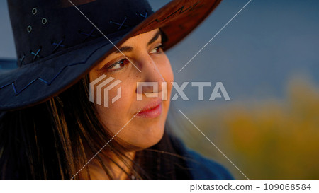 Close up shot of a young woman in a western style outfit in the Arizona desert Close up shot of a young woman in a western style outfit in the Arizona desert 109068584
