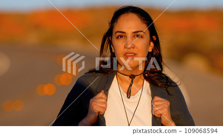 Beautiful woman posing for pictures at sunset in the desert 109068594