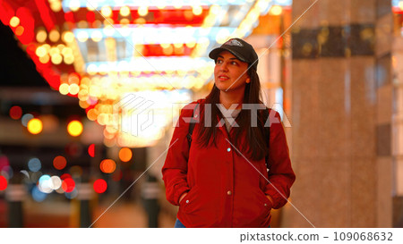 Young woman walking through Downtown Las Vegas Young woman walking through Downtown Las Vegas 109068632