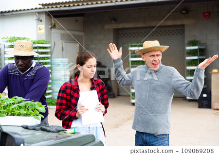 Girl manager quarreling with workers in a warehouse Girl manager quarreling with workers in a warehouse 109069208