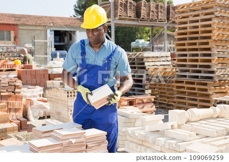 Male worker controlling quantity of ceramic tiles Male worker controlling quantity of ceramic tiles 109069259