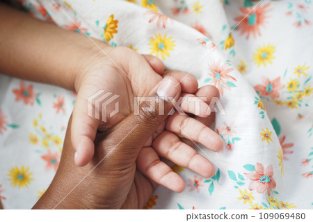 father holding hand of baby child,  109069480