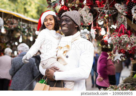 Happy man with joyful daughter Christmas fair Happy man with joyful daughter Christmas fair 109069905