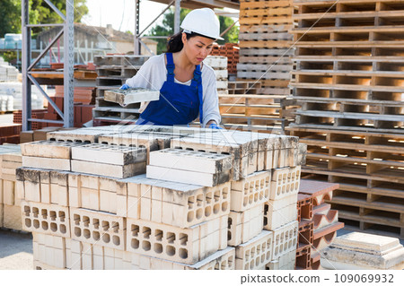 Taskmaster working in outdoor construction material storage 109069932