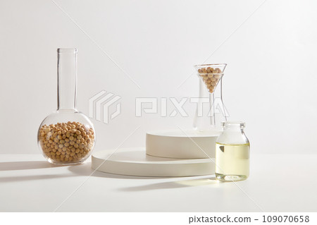 Two podiums stacked on top of each other decorated with few glassware of soybeans. A jar of soybean oil displayed. Soybean (Glycine max) can help maintain the elasticity of our skin Two podiums stacked on top of each other decorated with few glassware of soybeans. A jar of soybean oil displayed. Soybean (Glycine max) can help maintain the elasticity of our skin 109070658