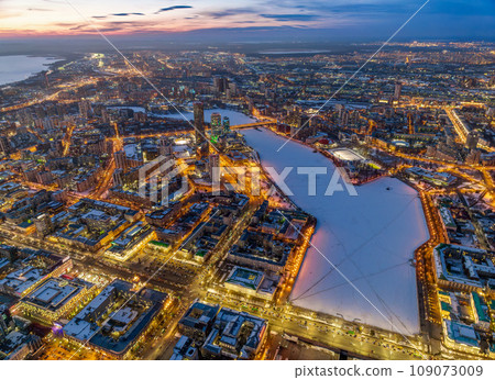 Embankment of the central pond and Plotinka in Yekaterinburg at winter sunset. The historic center of the city of Yekaterinburg, Russia, Aerial View Embankment of the central pond and Plotinka in Yekaterinburg at winter sunset. The historic center of the city of Yekaterinburg, Russia, Aerial View 109073009