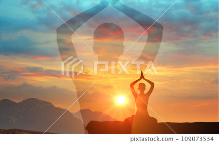 silhouette man practices yoga and meditates on mountain. serenity and yoga practicing at sunset, meditation. spiritual and mental health and peace of mind. Yoga meditation exercises 109073534