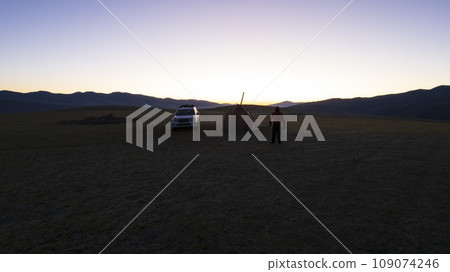Sunrise among green fields and hills. Camping 109074246