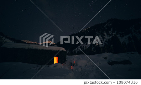 The night starry sky and a hut in the mountains The night starry sky and a hut in the mountains 109074316