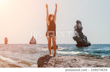 Woman summer travel sea. Happy tourist in hat enjoy taking picture outdoors for memories. Woman traveler posing on the beach at sea surrounded by volcanic mountains, sharing travel adventure journey Woman summer travel sea. Happy tourist in hat enjoy taking picture outdoors for memories. Woman traveler posing on the beach at sea surrounded by volcanic mountains, sharing travel adventure journey 109074656