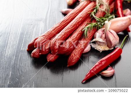 Smocked sausages with onion, garlic, pepper, and rosemary. 109075022