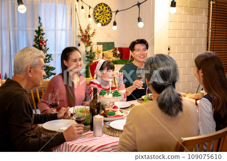 Happy people are celebrating on a table meal when christmas and new year at home. 109075610