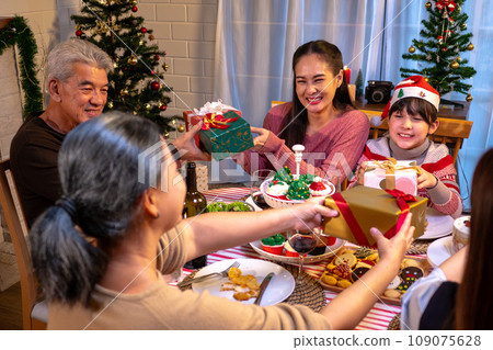 Happy people are celebrating on a table meal when christmas and new year at home. 109075628