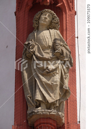 Saint John the Apostle statue on the portal of the Marienkapelle in Wurzburg, Bavaria, Germany Saint John the Apostle statue on the portal of the Marienkapelle in Wurzburg, Bavaria, Germany 109075870