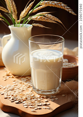 Alternative milk from oats in a glass on the table Alternative milk from oats in a glass on the table 109075940