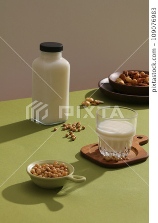A dish containing a lot of soybeans displayed with a glass and bottle of soybean milk. Soy extract can be found in a wide range of skincare products A dish containing a lot of soybeans displayed with a glass and bottle of soybean milk. Soy extract can be found in a wide range of skincare products 109076983