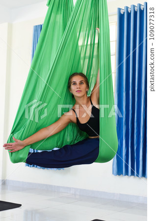 Young woman making aerial or fly yoga pose Young woman making aerial or fly yoga pose 109077318
